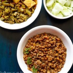 akkha Masoor garnished with coriander leaves and served in a white bowl.