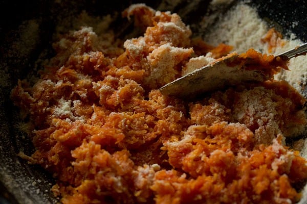 mixing milk powder with grated carrot.