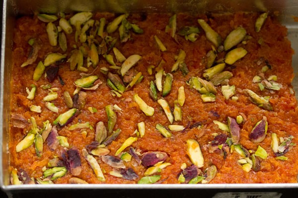 chopped pistachios sprinkled on the spread barfi mixture. 