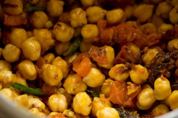 mixing chickpeas with the masala