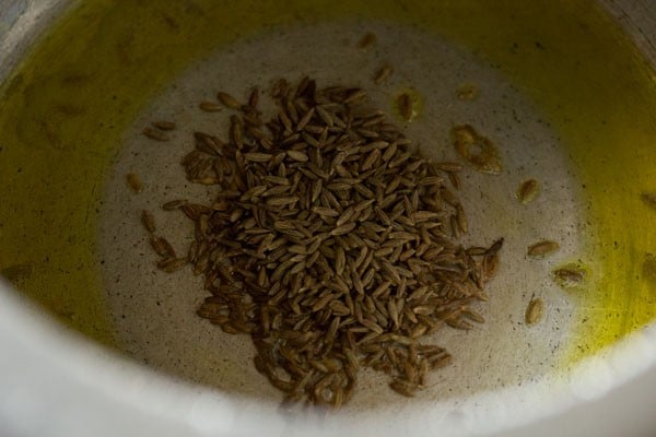 sautéing cumin seeds in hot oil in pressure cooker. 