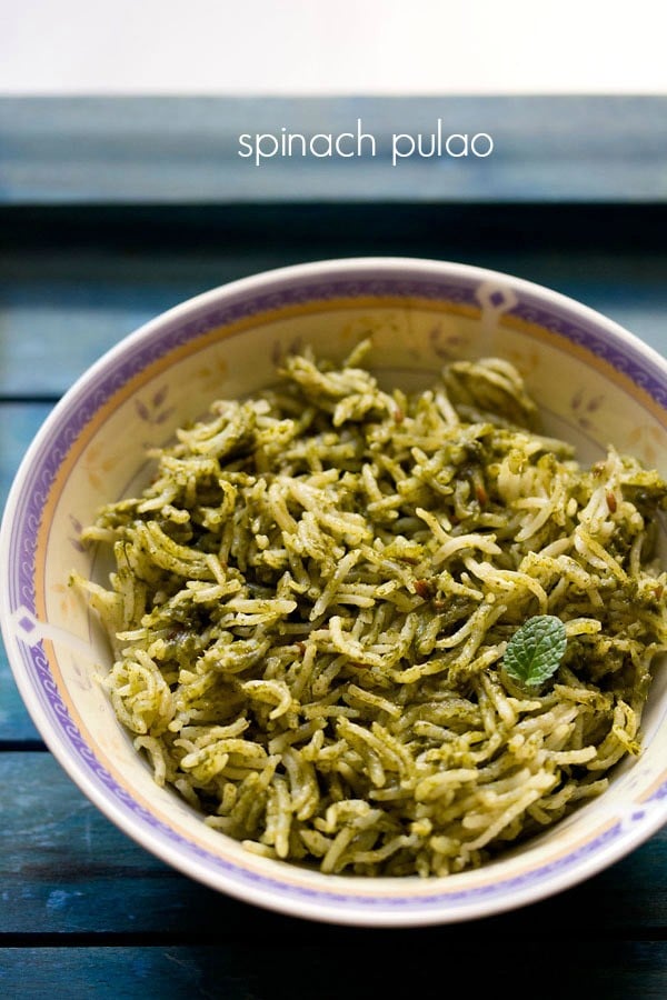 Palak rice garnished with a mint leaf in a bowl