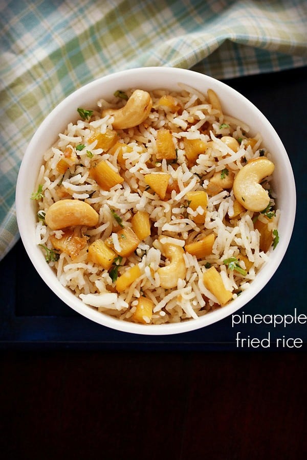 pineapple fried rice served in a white bowl with text layovers.