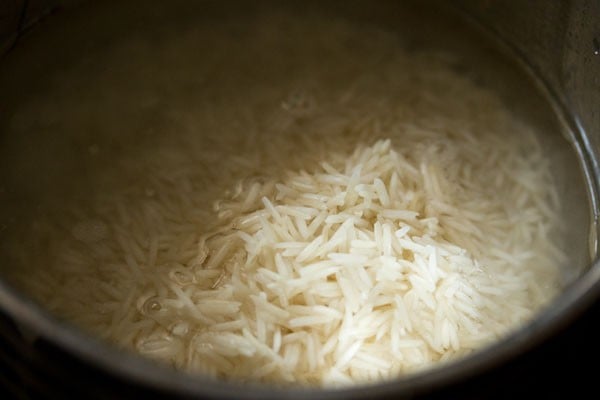 cooking the rice in the pot. 