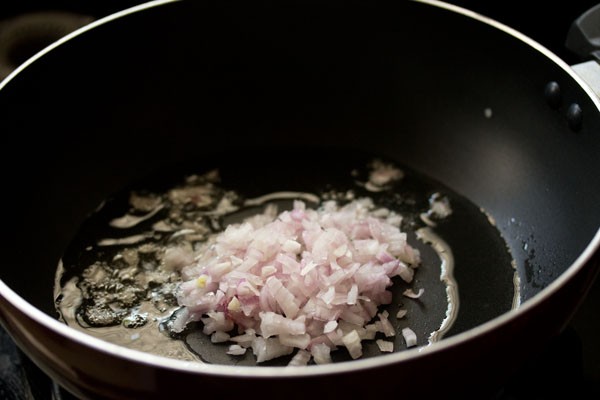 chopped onions added to hot oil in wok. 