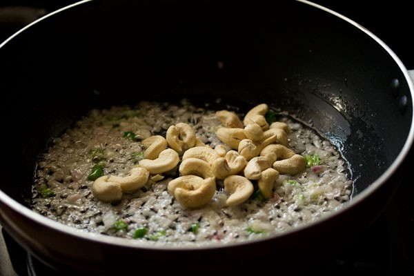 cashews added in the wok.