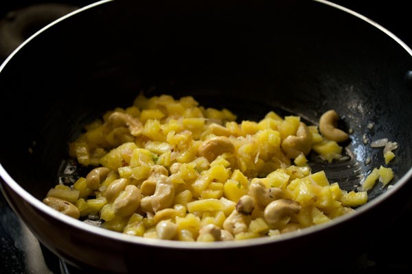 sautéing pineapple cubes in the wok. 