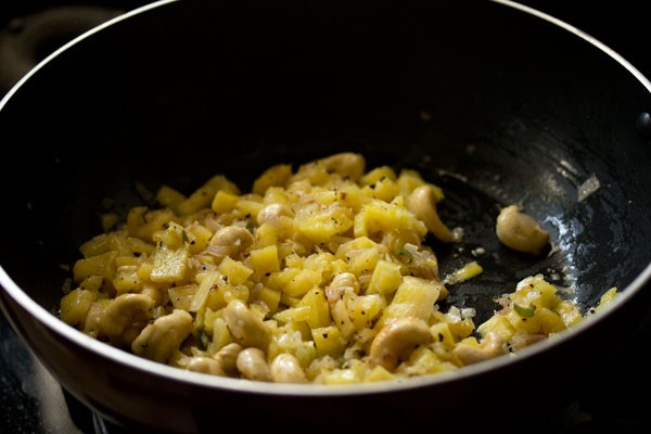 mixing ingredients in the wok. 