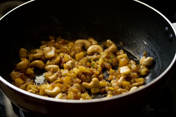 mixing the sauces with other ingredients in the wok. 