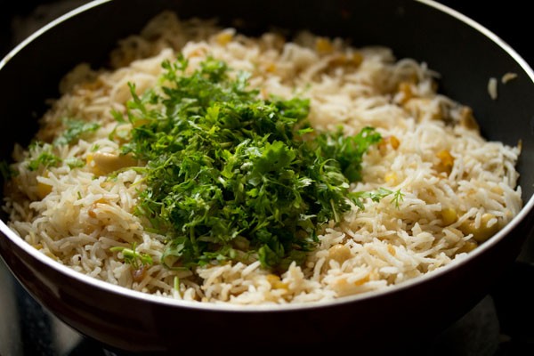 chopped coriander leaves added to the pineapple fried rice. 