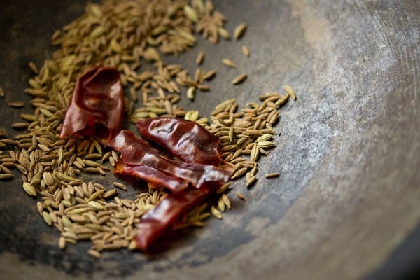 red chili added to cumin seeds and fennel