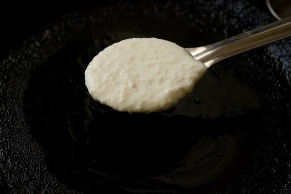 rava uttapam batter in a large serving spoon
