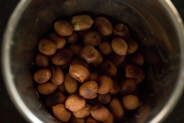 roasted peanuts added to a mortar. 