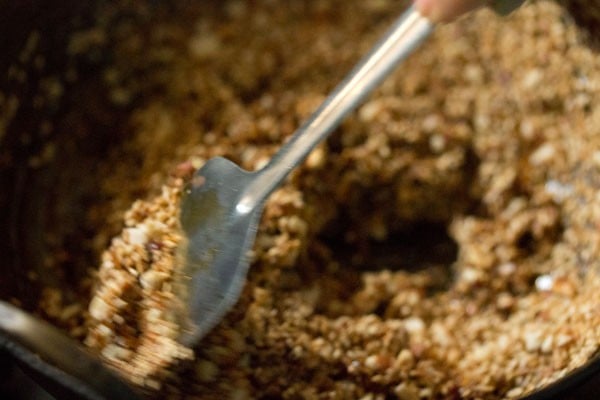 mixing roasted mixture and jaggery syrup quickly. 