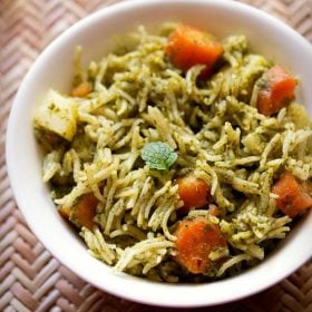 green pulao served in a white bowl.