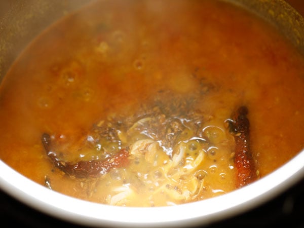 pour the entire tempering mixture in the dal