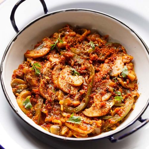 instant pot kadai mushroom served in a small enameled white wok on a white plate