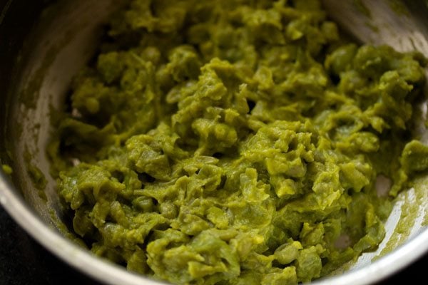 mashing steamed peas