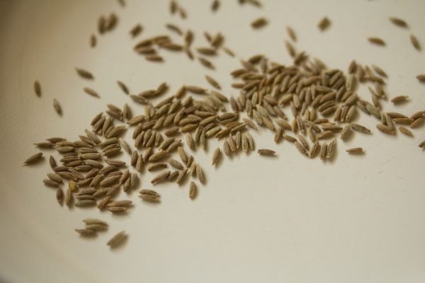 roasting cumin seeds in a pan