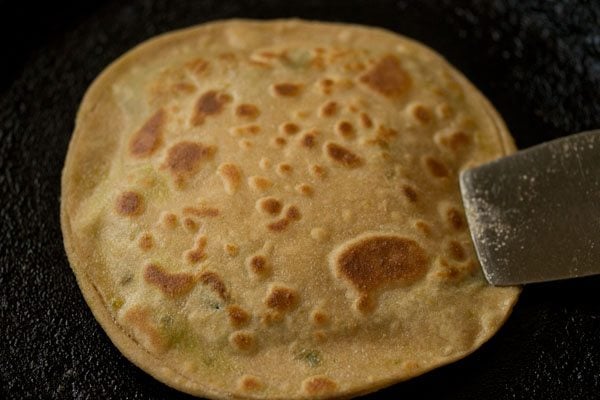 cooked peas paratha on tawa