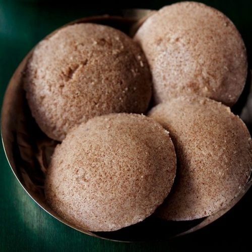 ragi idli served in a steel bowl.