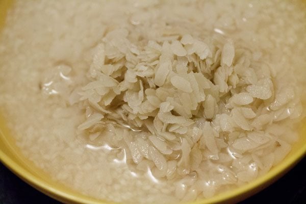 thick poha added to the soaking idli rice. 