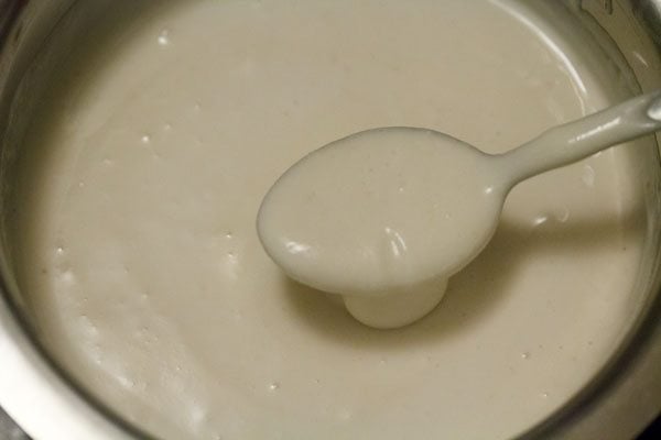 mixing rice-poha batter in the urad dal batter well. 