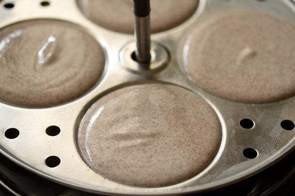 batter poured in greased idli  moulds. 