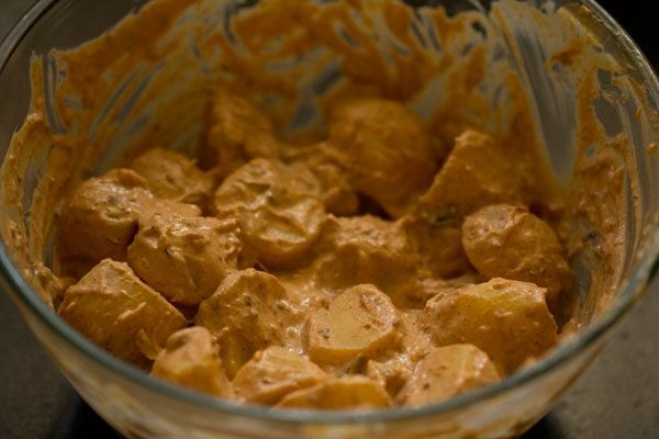 marinating potatoes for tandoori aloo marinade. 