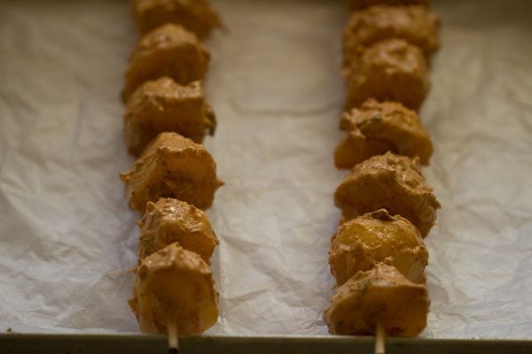 marinated skewered and placed on a butter paper lined baking tray. 