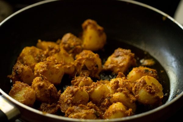 pan frying potato pieces on the other side. 