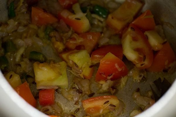 sauteing tomatoes for making masala khichdi