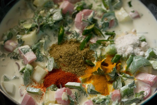 chopped green chilies, ground spices and salt added to coconut milk mixture. 