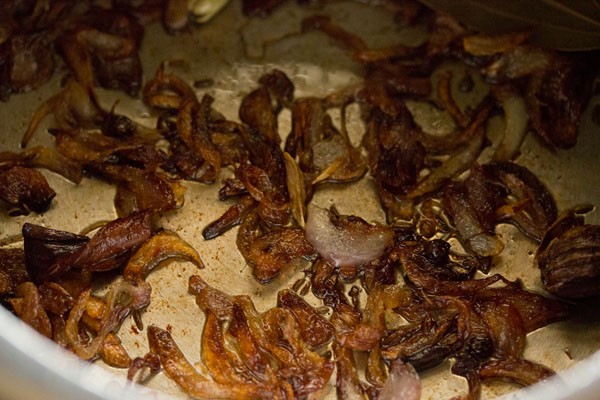 fried onions spread in the pressure cooker. 