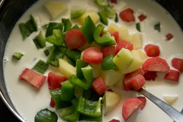 chopped mixed vegetables added to coconut milk. 