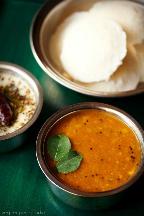 tomato sambar served with idli and coconut chutney