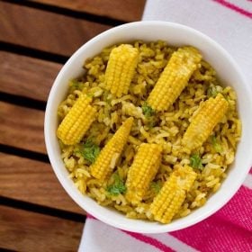 baby corn pulao served in a white bowl.
