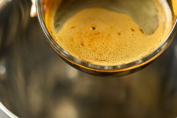 pouring instant coffee mix into a blender.