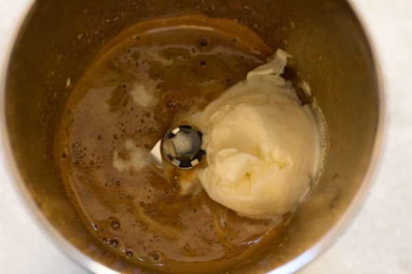 adding vanilla coffee to blender to make coffee milkshake.