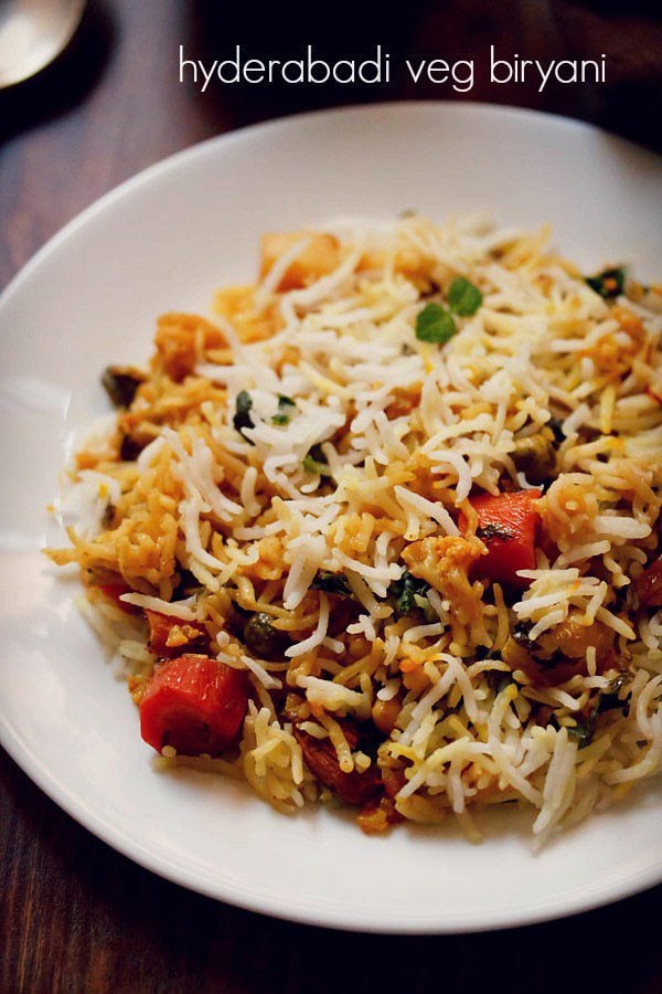 veg biryani on a white plate with text layovers.