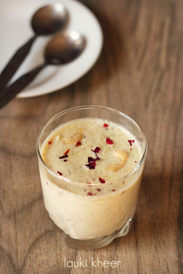 lauki ki kheer garnished with crushed dried rose petals and served in a glass with text layover.