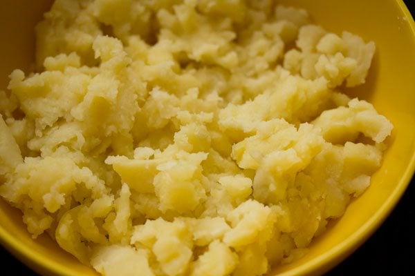 peeled and crumbled potatoes in a bowl. 