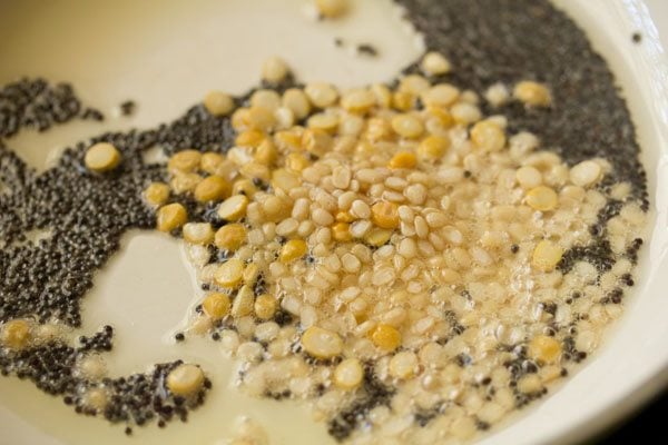 urad dal and chana dal added to the spluttering mustard seeds. 