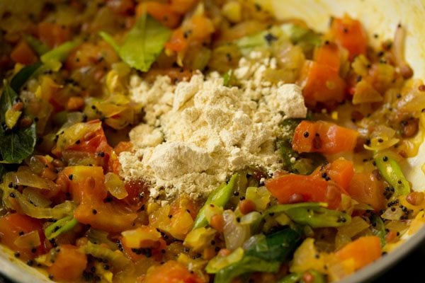 gram flour added to the onion-tomato mixture. 