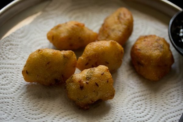 draining fried punukulu on paper towels.