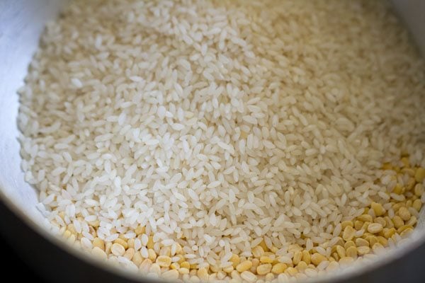 rice added to the roasted mung lentils in the bowl