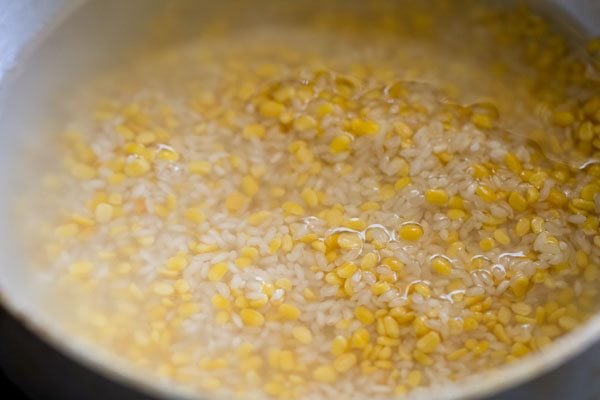 water floating above lentils and rice