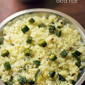 bhindi rice served on a steel plate with a side of plain curd.