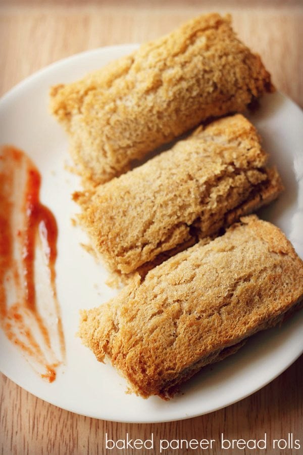 paneer bread roll served on a plate with some tomato ketchup on the side and text layover. 