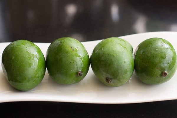 green mangoes kept on a tray.